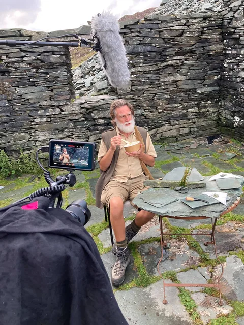 Behind the scenes: Peter Macqueen eats lunch in the bothy ruin between takes, surrounded by camera and boom.